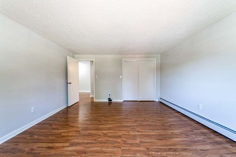 A room with wooden floors and white walls.