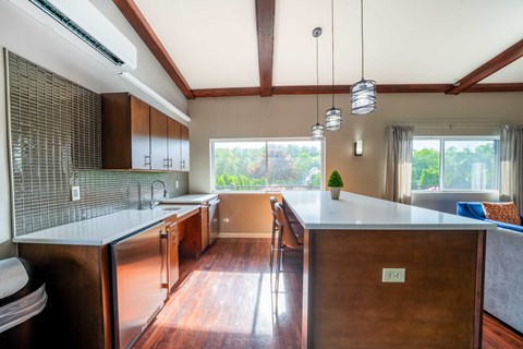 A kitchen with a wooden island and stainless steel appliances.