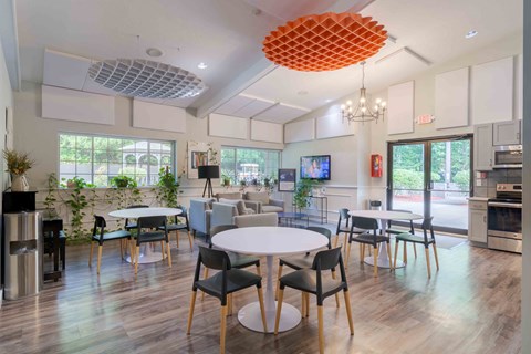 A modern dining room with a white table and chairs.