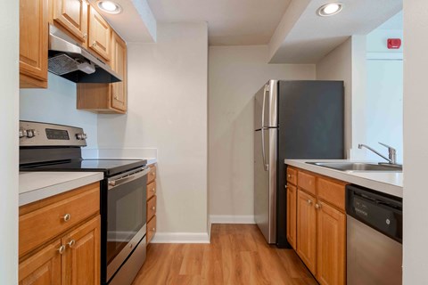 A kitchen with wooden cabinets and stainless steel appliances.