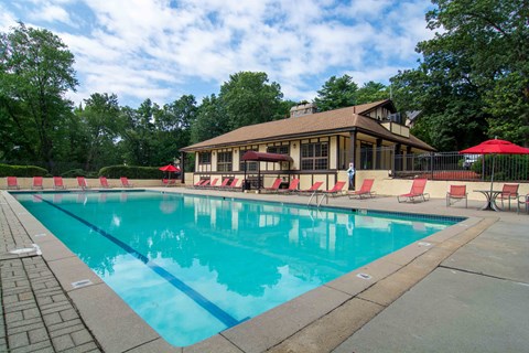 A large swimming pool with a building behind it.