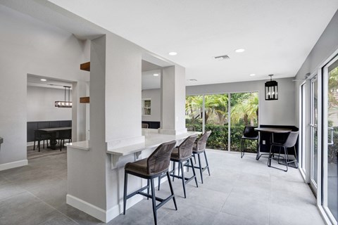 A dining room with a table and chairs.