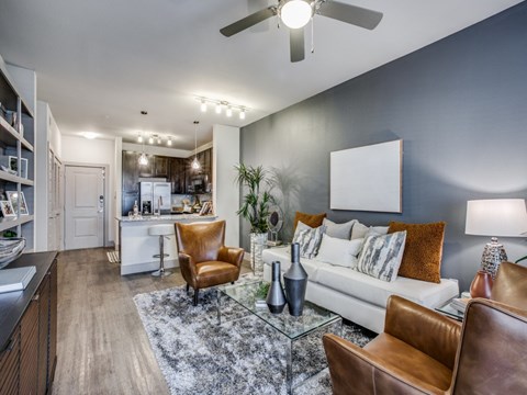 A modern living room with a brown leather chair and a glass coffee table.