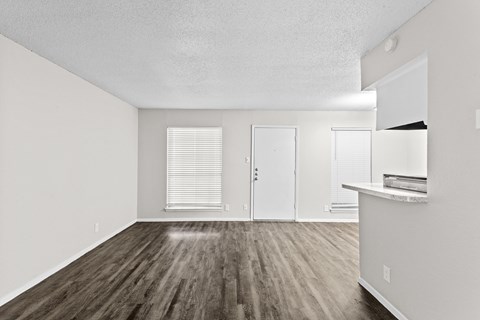 A room with wooden floors and white walls.