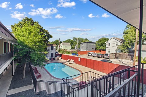 A pool surrounded by a black fence.