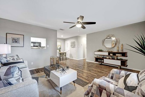 A living room with a grey couch and a white coffee table.