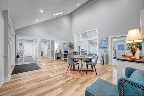 A modern living room with a dining table and chairs.