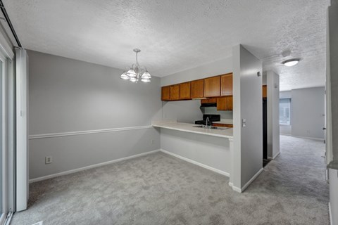 A room with a grey carpet and a white ceiling.