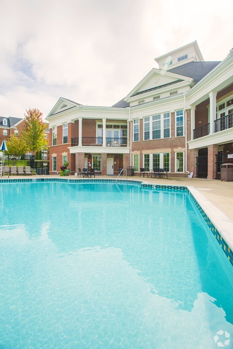 A large swimming pool in front of a building.