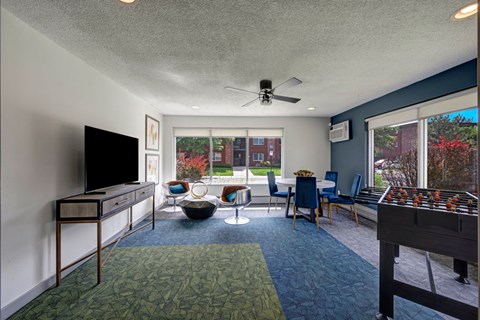 A room with a television and a pool table.