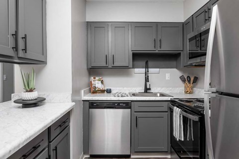 A modern kitchen with a stainless steel dishwasher and oven.