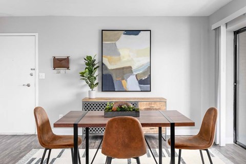 A dining room with a table and chairs.
