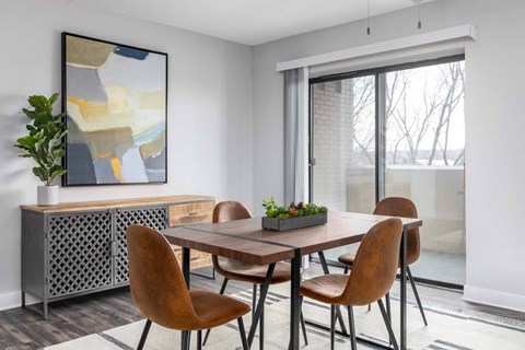 A dining room with a wooden table and chairs.