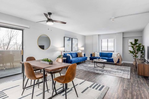 A modern living room with a dining table and chairs.