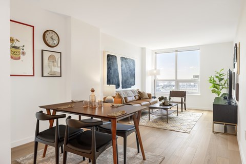 A dining room with a wooden table and chairs.