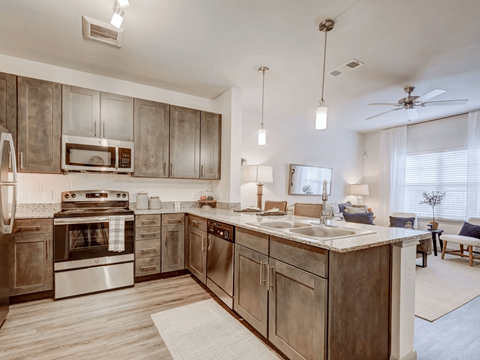 A kitchen with wooden cabinets and stainless steel appliances.