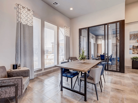 A dining room with a table and chairs.