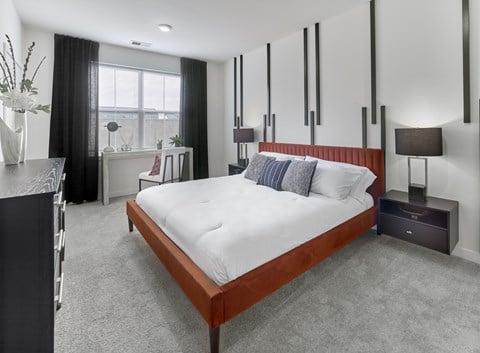 A modern bedroom with a large bed and a window.