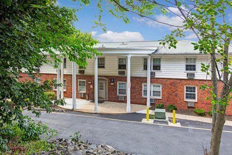A building with a red brick facade and white columns.
