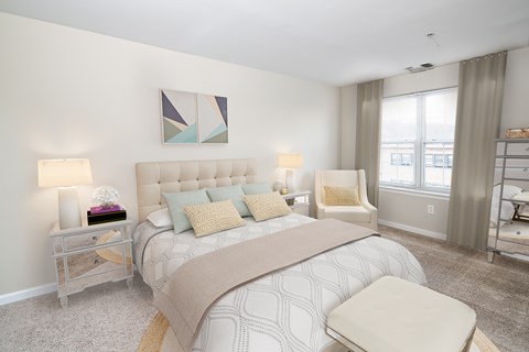 A bedroom with a large bed and a painting on the wall.
