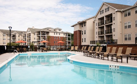 A swimming pool in front of apartment buildings.