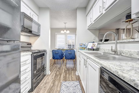 A kitchen with a black oven and a black fridge.