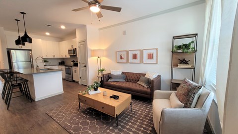 A living room with a brown couch and a coffee table.