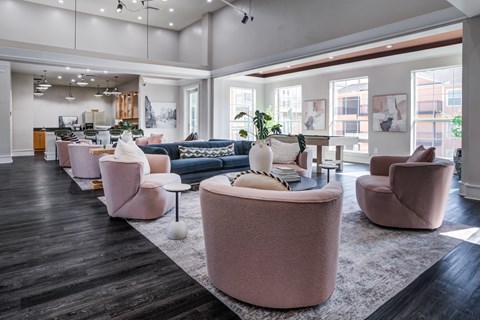 A living room with a pink sofa and matching ottoman.