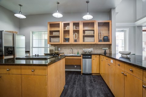 A kitchen with wooden cabinets and a black countertop.