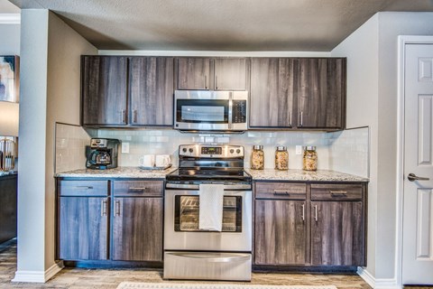 A kitchen with wooden cabinets and stainless steel appliances.