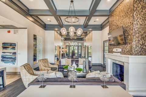 A living room with a fireplace and a large painting on the wall.