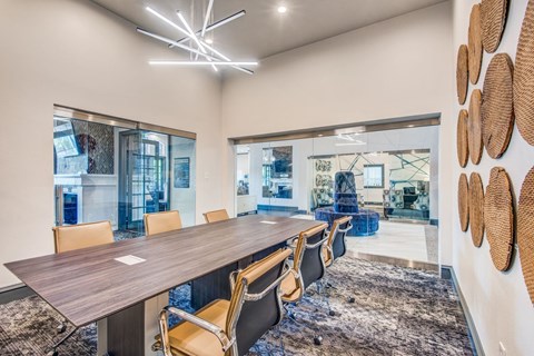 A conference room with a long table and chairs.