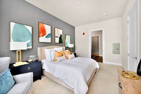 A bedroom with a large bed and a couch.