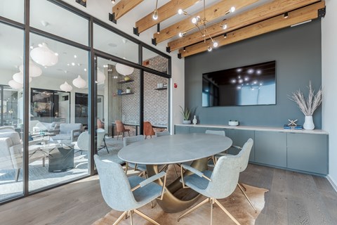 A modern dining room with a glass table and chairs.