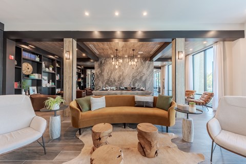 A modern living room with a large sectional sofa and a wooden coffee table.