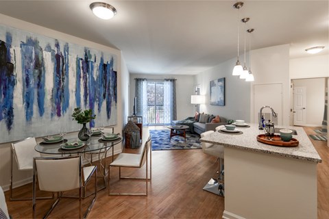 A modern kitchen with a dining table and chairs.