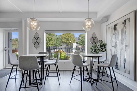 A dining room with a table and chairs.