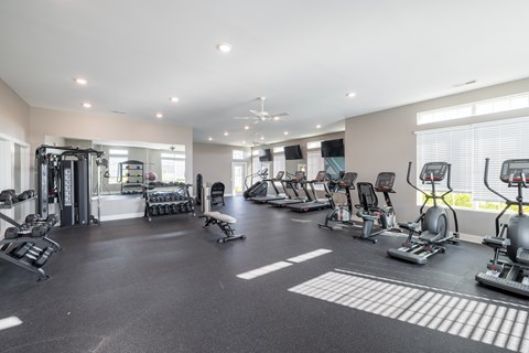 A spacious gym with a variety of exercise equipment.