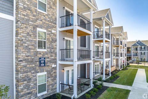Apartment building with balconies and doors numbered 306 and 308.
