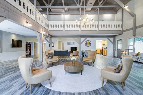 A living room with a large clock on the wall.