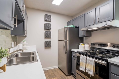 A kitchen with a stainless steel refrigerator and oven.