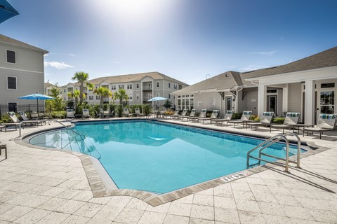 A sunny day at the poolside with a clear blue sky.