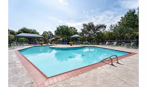 A large outdoor swimming pool with a red border.
