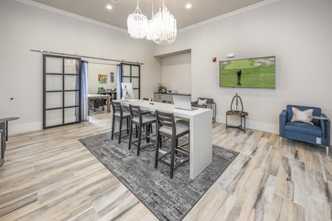 A modern dining room with a large table and chairs.