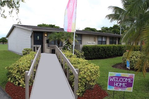 A building with a sign that says "Welcome Home" in front of it.