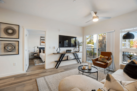 A living room with a flat screen TV and a chair.