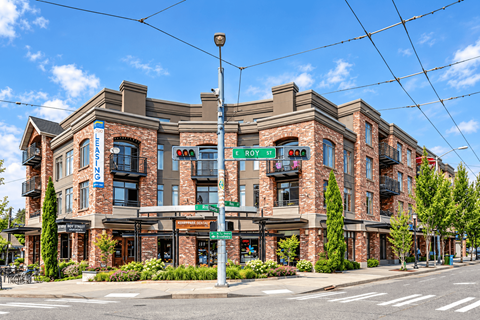 A street view of a building with a sign that says "ROY ST".