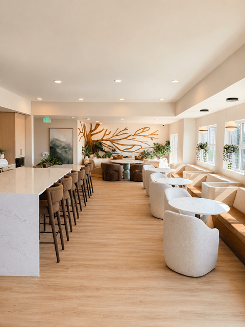 A modern dining area with a long table and chairs.
