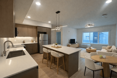 A modern kitchen with a dining table and chairs.