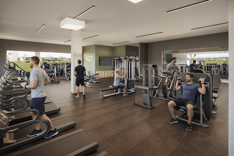 A gym with people exercising and a sign that says "YGT".